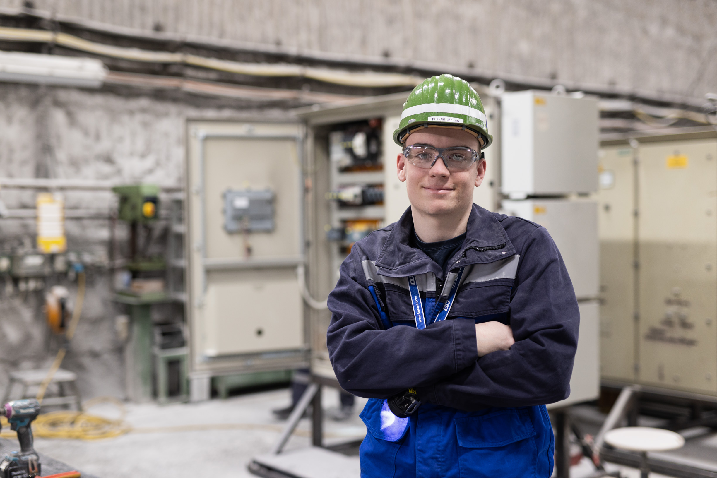 Elektroniker:in bei der Arbeit an einer technischen Anlage